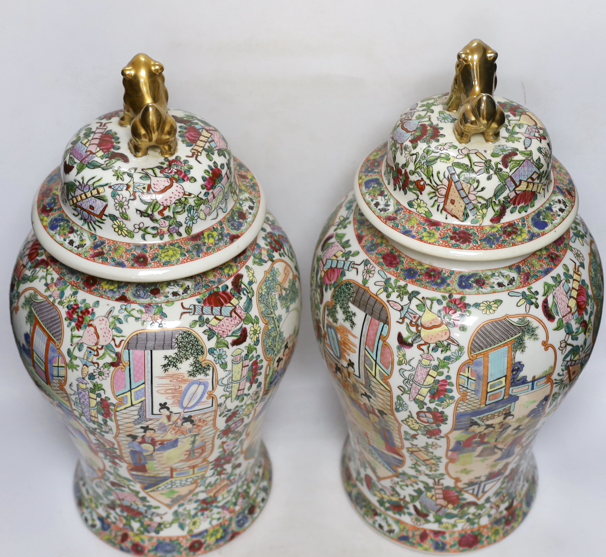 A pair of Chinese famille rose lidded vases, 49cm high